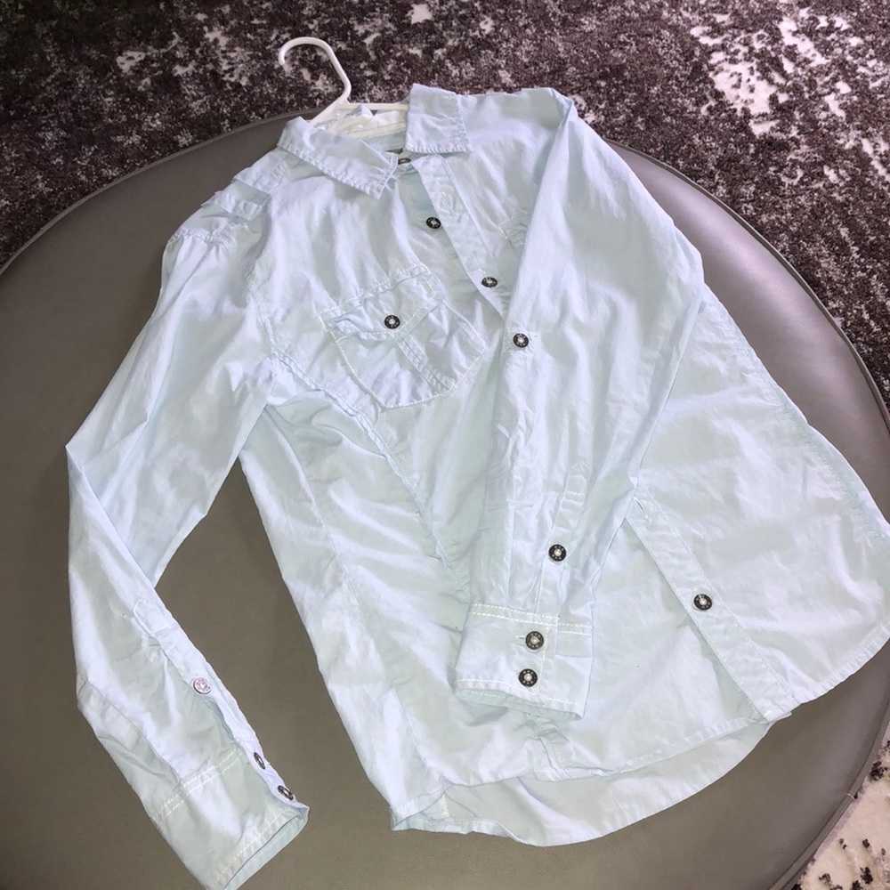 Powder blue collared button down shirt.